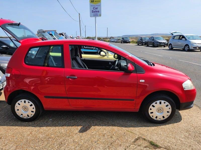 A red Volkswagen Fox viewed from the right side