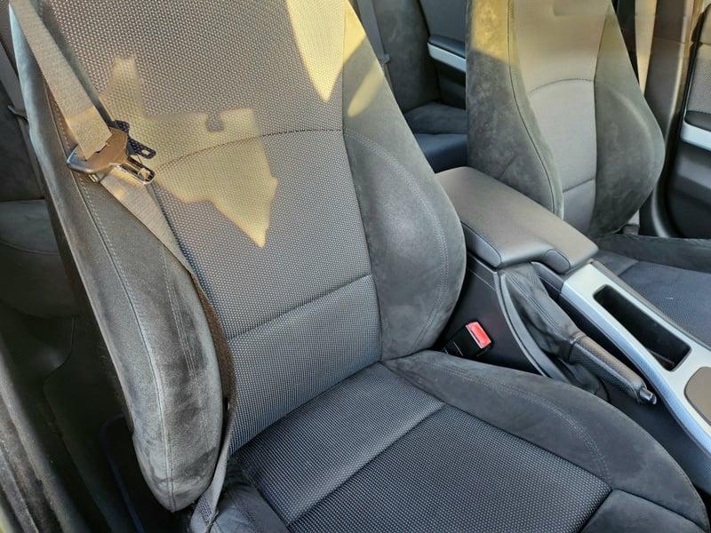 The front seats, handbrake, and lower center console of a BMW 3 Series 320d M Sport