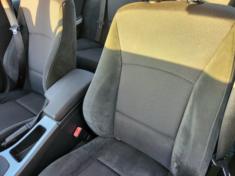 The front seats, handbrake, and lower center console of a BMW 3 Series 320d M Sport from the left