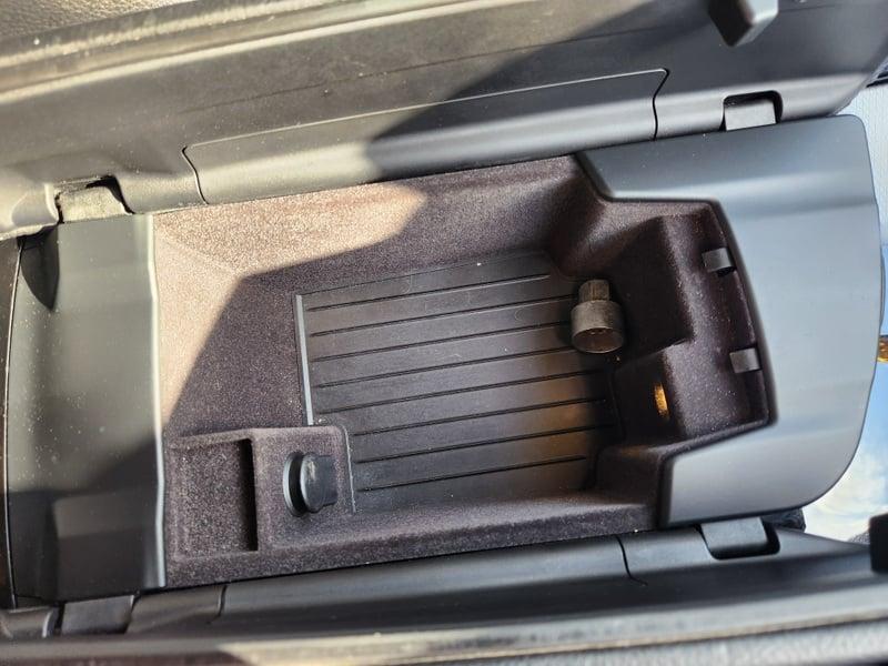 The lower console storage area of a BMW 5 Series Touring 520d M Sport Auto