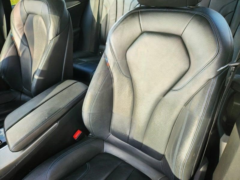 The front seats of a BMW 5 Series Touring 520d M Sport Auto