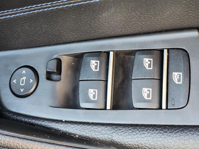 Window controls on the right door of a BMW 5 Series Touring 520d M Sport Auto