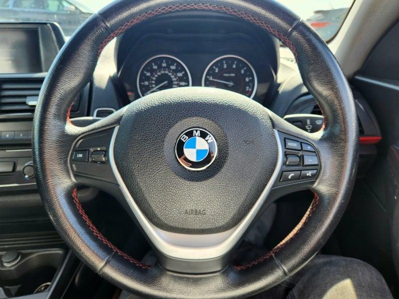 The steering wheel of a black BMW 1 Series 116i Sport