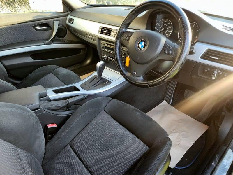 The front seats, steering wheel, and controls of a BMW 3 Series 320d M Sport from the right