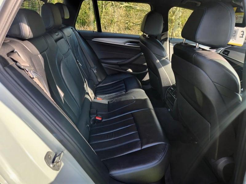 The back seats of a BMW 5 Series Touring 520d M Sport Auto from the right side