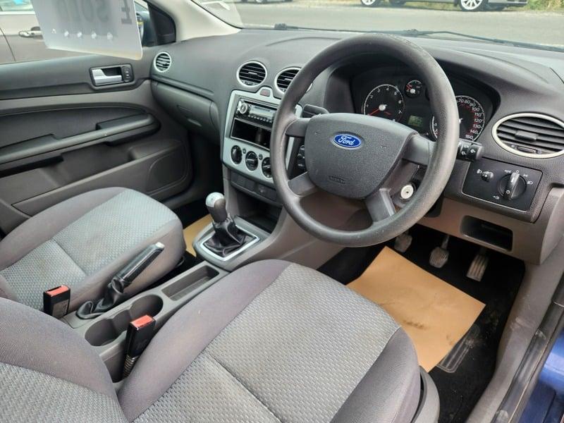 The front seats, steering wheel, and controls of a right-hand drive Ford Focus 1.6 Estate, from the right side.