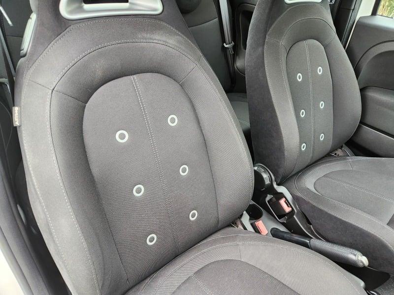 The front seats and lower center console of a Fiat Abarth 1.4 from the right side.