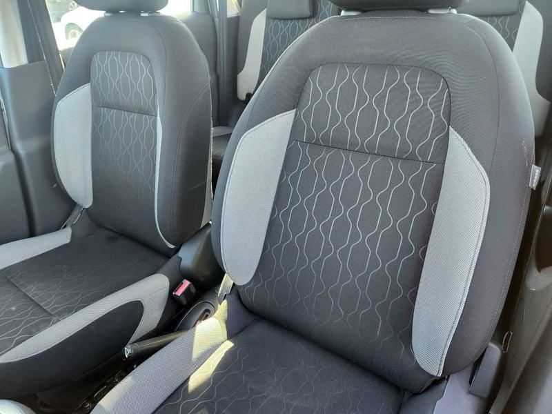 The front and rear seats and lower center console of a Citroen C3 Picasso 1.4 from the left side.