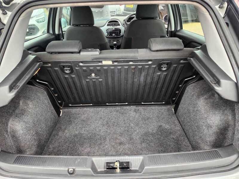 The boot of a white Fiat Punto 1.4 Evo from behind.