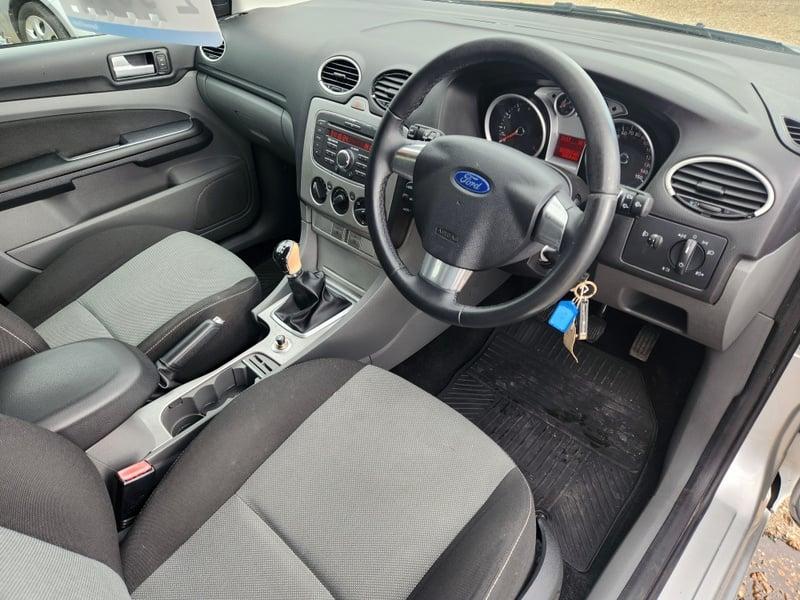 The front seats, steering wheel, and controls of a right-hand drive Ford Focus Zetec 125, from the right side.