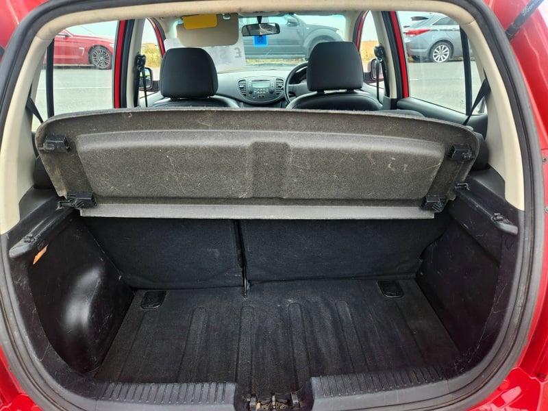The boot of a Bright Red Hyundai i10, viewed from behind.