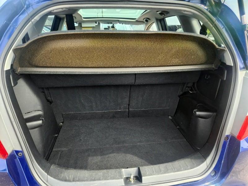 The boot of a blue Honda Jazz, viewed from behind.