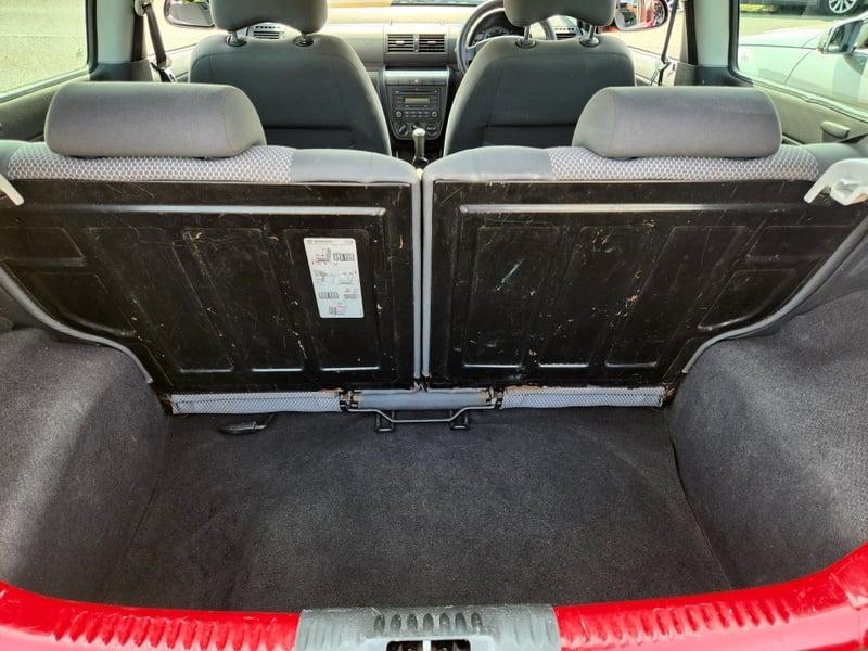 The boot of a red Volkswagen Fox, viewed from behind.