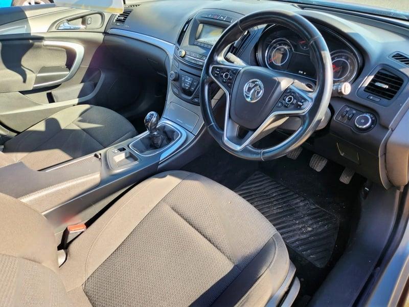 The front seats, steering wheel, and controls on a silver Vauxhall Insignia Sport Tourer Eco Flex, viewed from the right side.