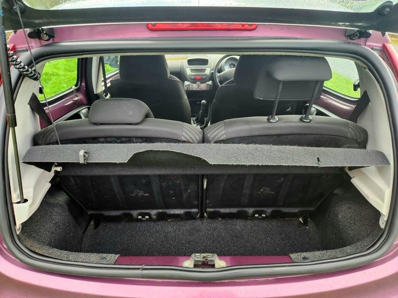 The boot of a purple Peugeot 107 1.0 Active, viewed from behind.