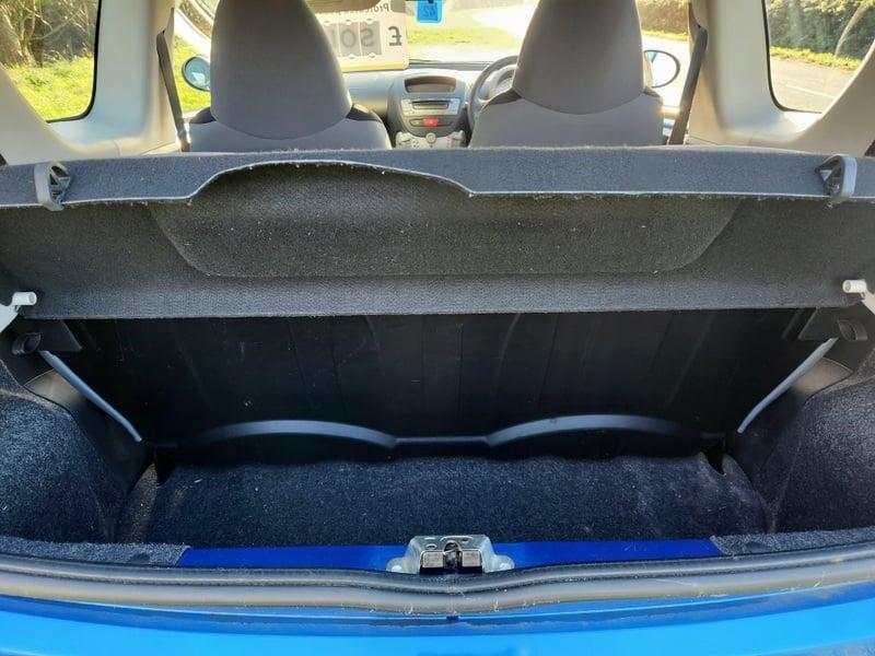 The boot of a blue Peugeot 107 1.0 Access, viewed from behind.