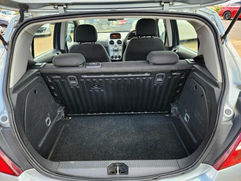The boot of a silver Vauxhall Corsa Excite, viewed from behind.