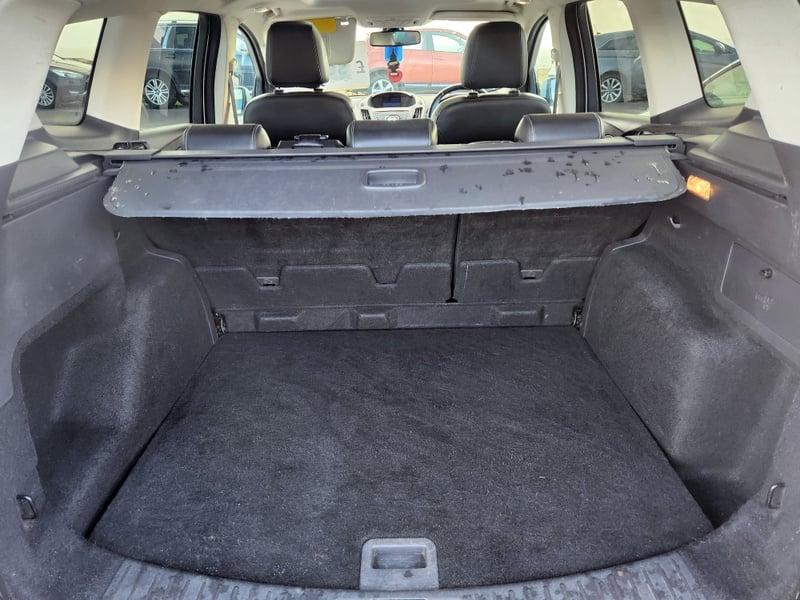 The boot of a white Ford Kuga Titanium X viewed from behind.