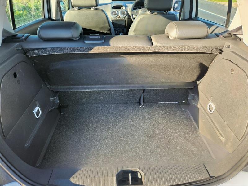 The boot of a white Vauxhall Corsa 1.4 SE viewed from behind 