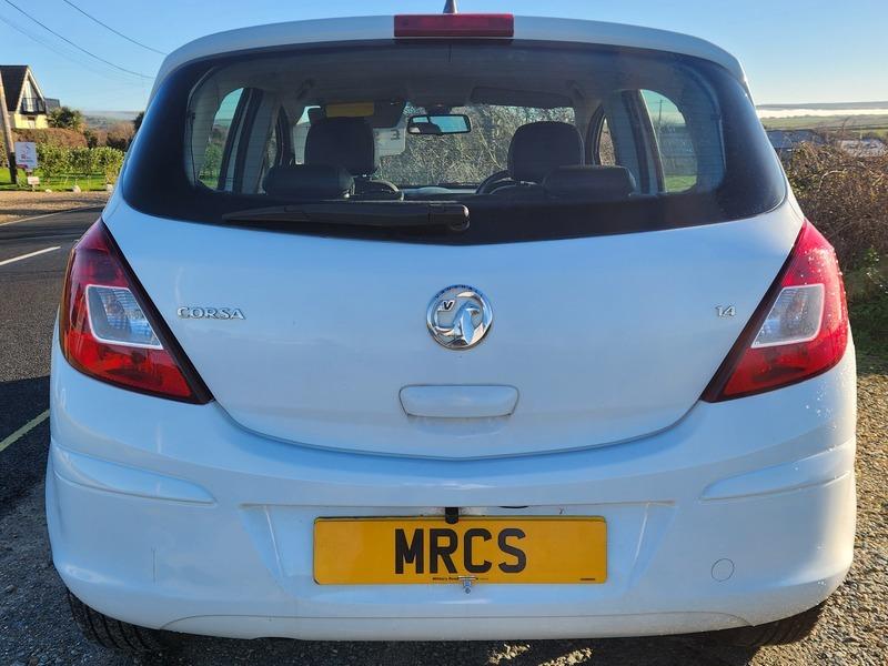 A white Vauxhall Corsa 1.4 SE viewed from behind