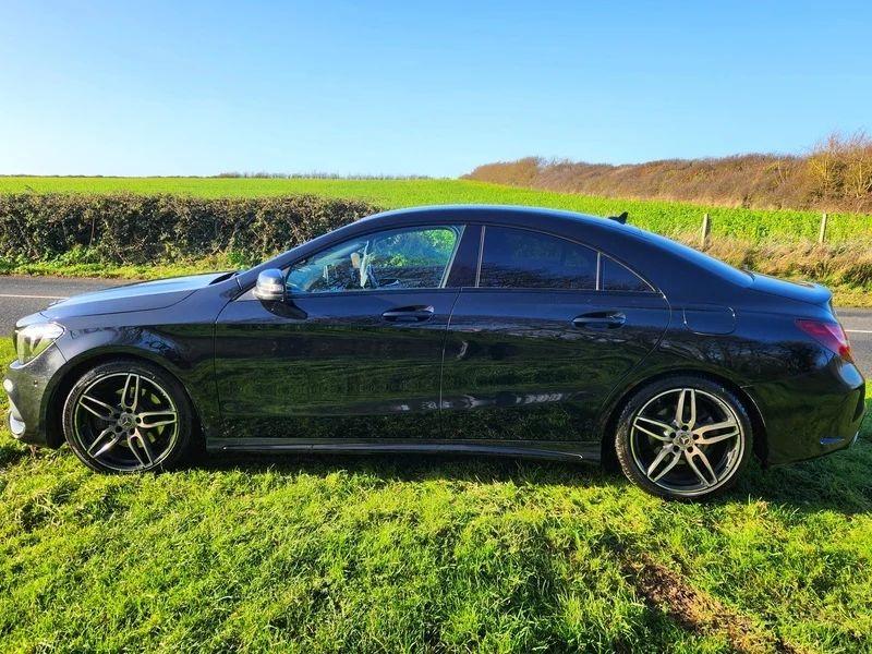 A black Mercedes viewed from the passenger side