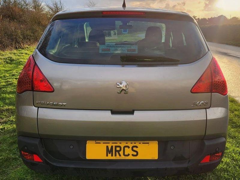The back of a grey Peugeot 3008 viewed from behind