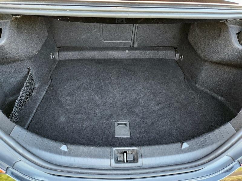 The boot of a black Mercedes viewed from behind.