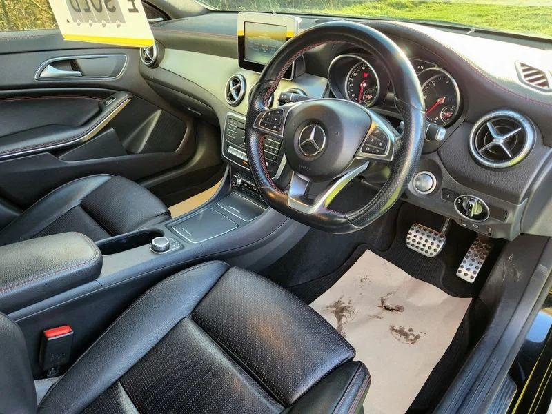 The controls of a black Mercedes viewed from the driver position