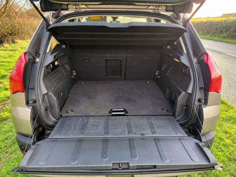 The boot of a grey Peugeot 3008 viewed from behind