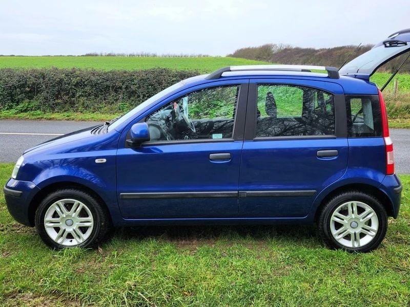 A blue Fiat Panda viewed from the passenger side with the hatch open