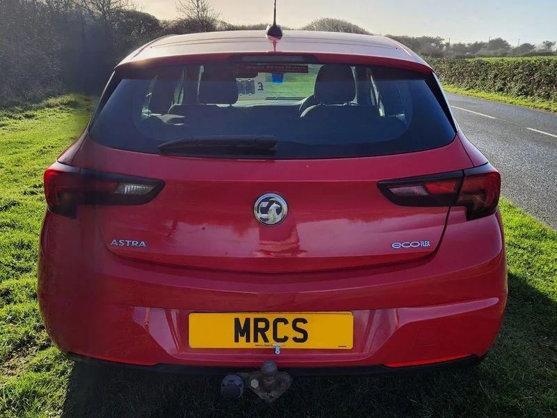 The back of a Power Red Vauxhall viewed from behind