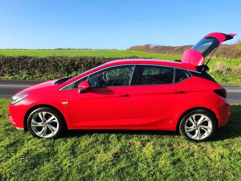A Power Red Vauxhall Astra viewed from the passenger side