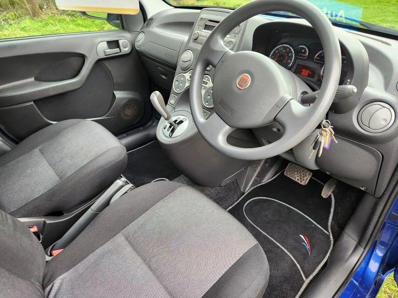 The steering wheel and controls of a FIat Panda viewed from the driver's side