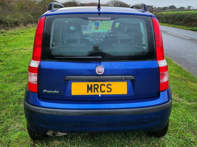 The back of a blue Fiat Panda viewed from behind