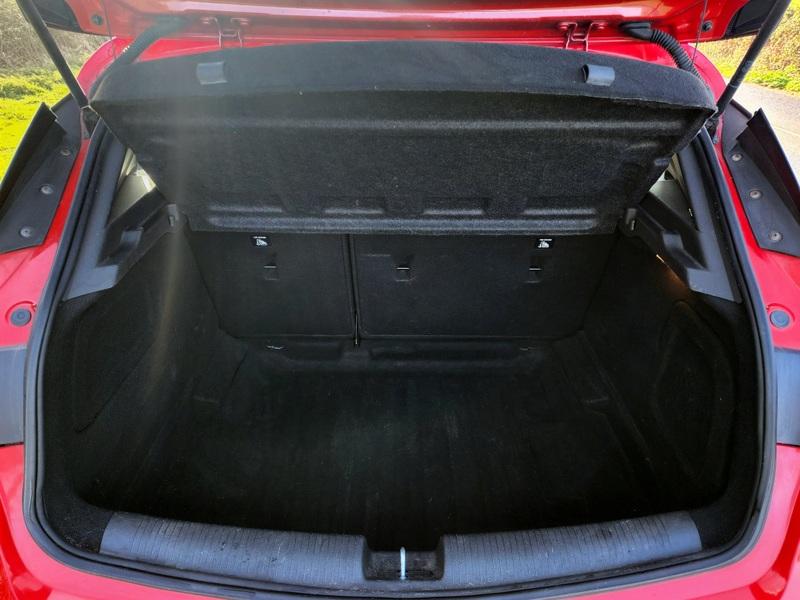 The boot of a Power Red Vauxhall Astra viewed from behind