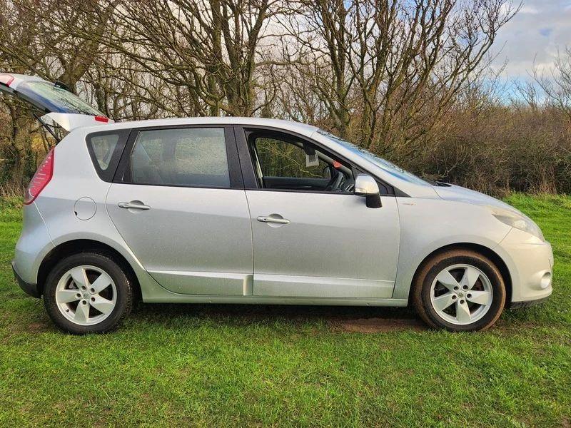 A silver Renault Scenic viewed from the driver side