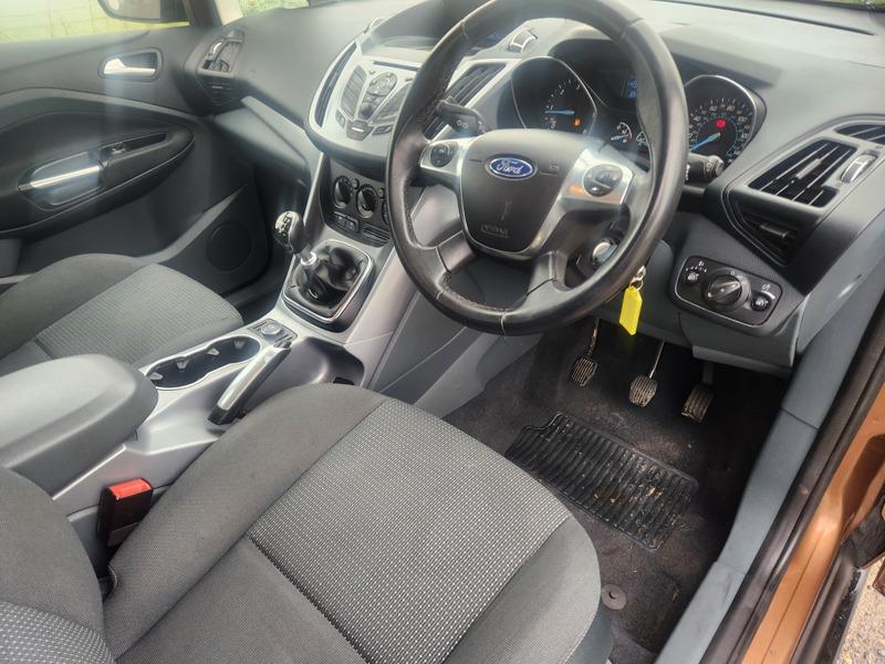 The front interior of a brown Ford C Max viewed from the driver seat