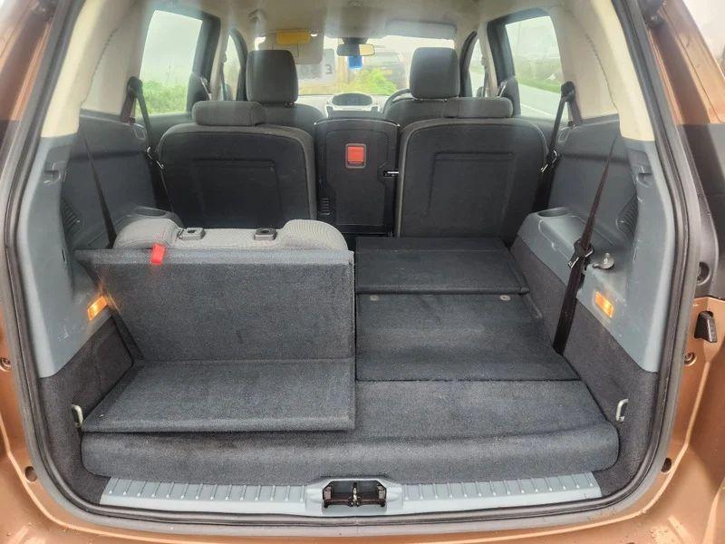 The rear interior boot area of a brown Ford C Max, with the hatch door open, viewed from behind the car