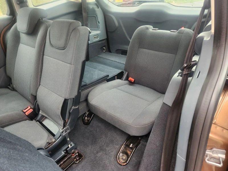 The back interior of a brown Ford C Max viewing behind the passenger seat