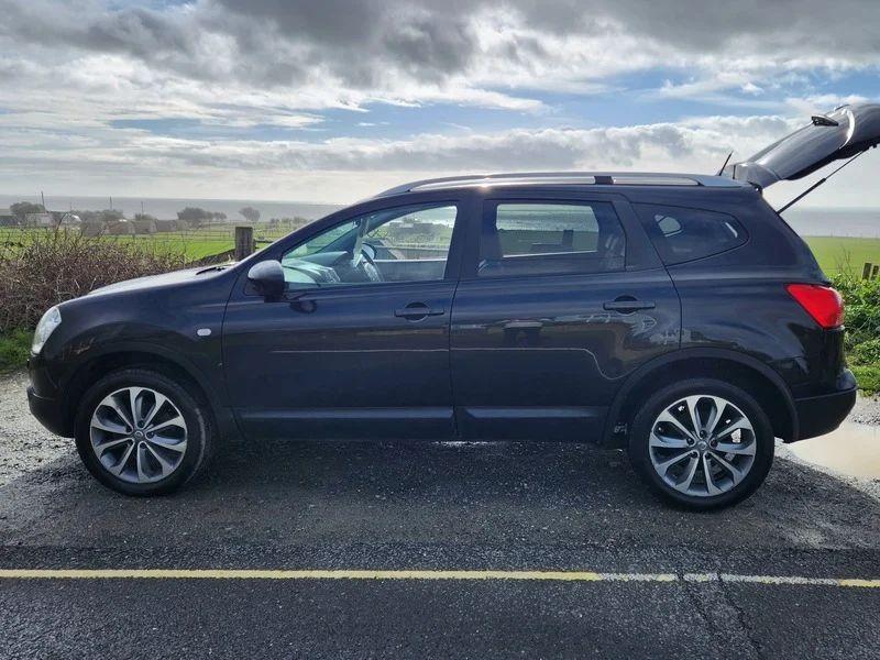 A black Nissan Qashqai viewed from the passenger side