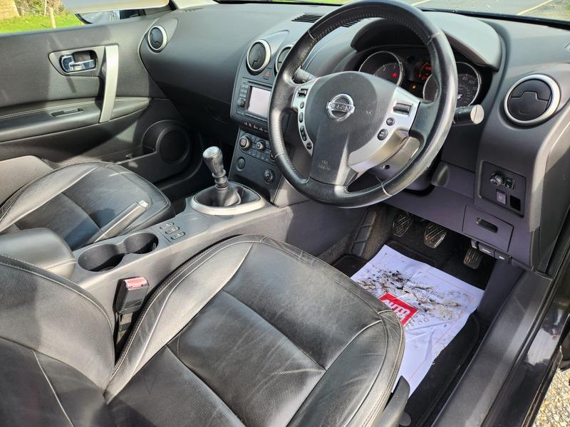 A black Nissan Qashqai front interior viewed from the driver side