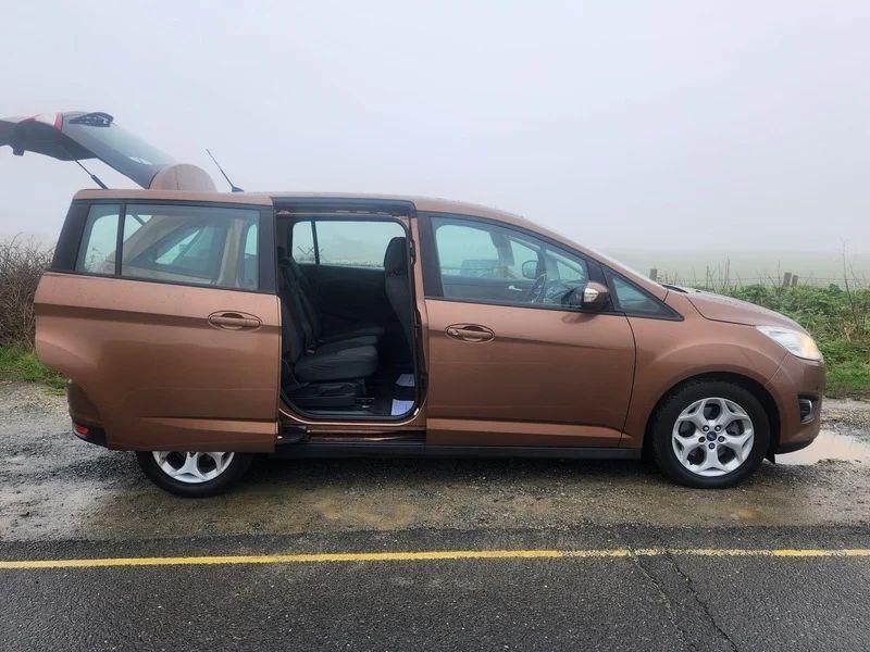 A brown Ford C Max, with the rear door open, viewed from the driver side