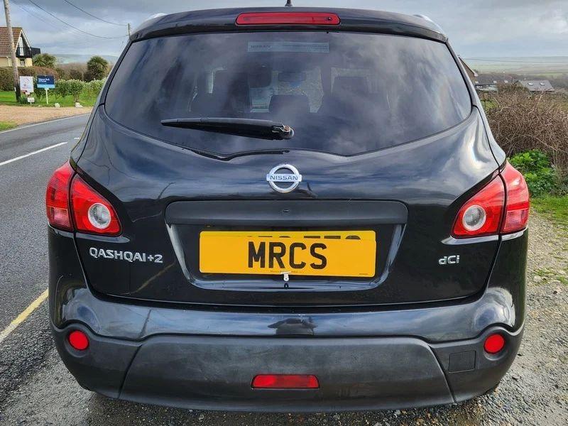 A black Nissan Qashqai viewed from behind