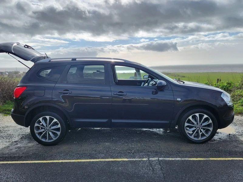 A black metallic Nissan Qashqai viewed from the driver side