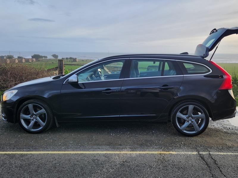 A black Volvo V60 Estate viewed from the passenger side