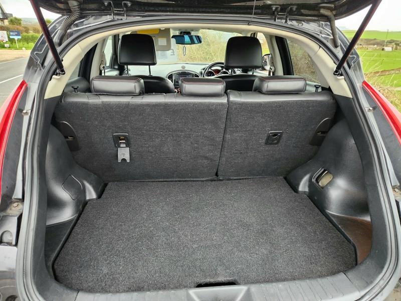 The open boot of a Nissan Juke viewed from behind the car