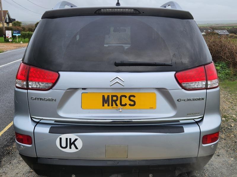 A silver Citroen C-Crosser viewed from behind