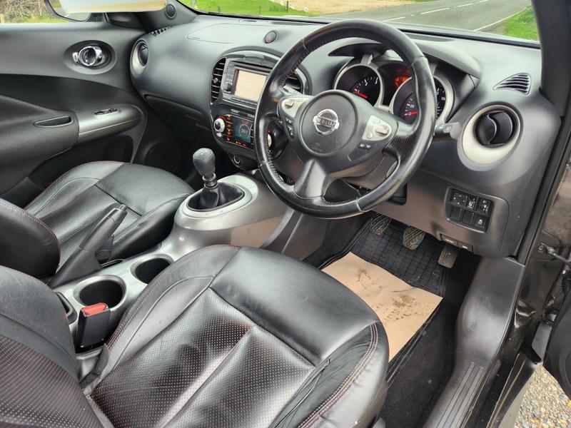 The steering controls of a black Nissan Juke viewed from above the driver seat