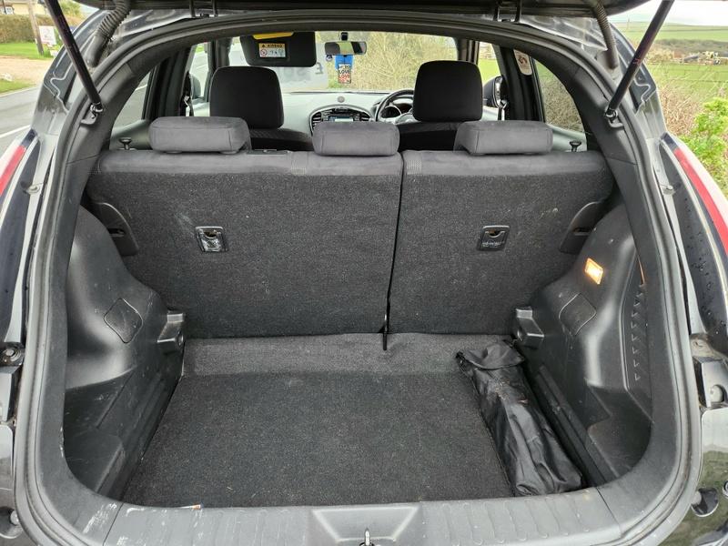 The boot os a black Nissan Qashqai viewed from behind the car