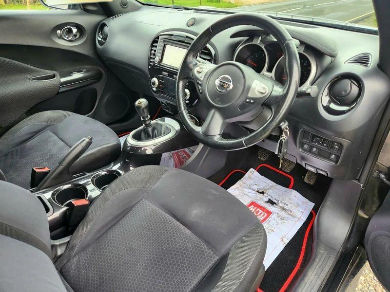 The front interior of a black Nissan Qashqai viewed from above the driver seat